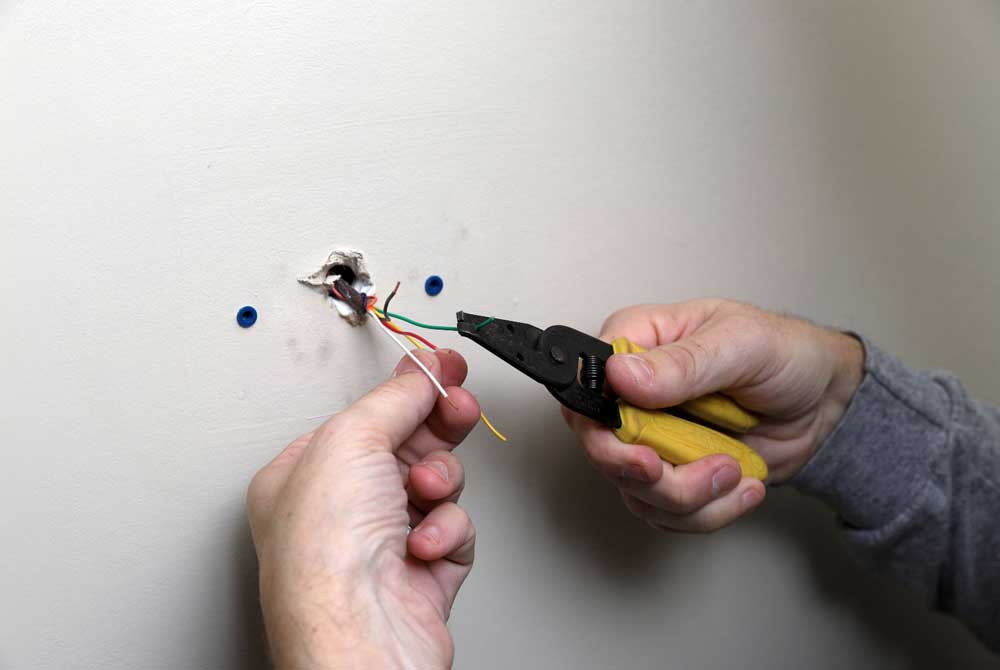 A technician repairing a thermostat.