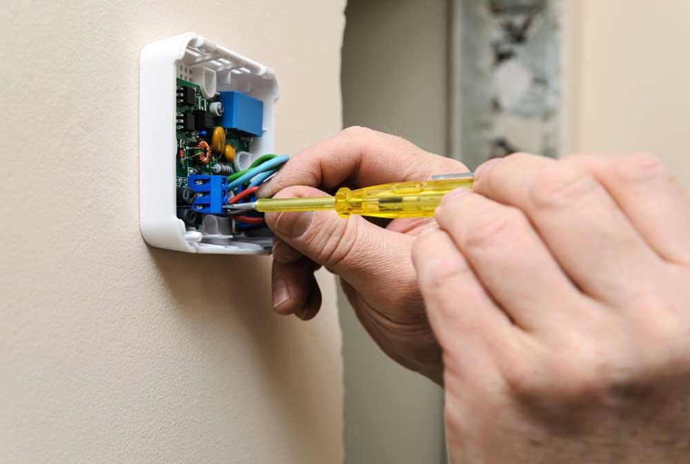 Digital thermostat installed and tested by an HVAC technician.