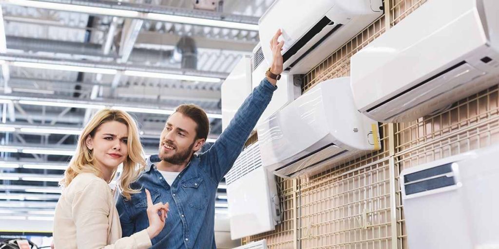 HVAC technician helping a Titusville homeowner choose the best type of AC unit.