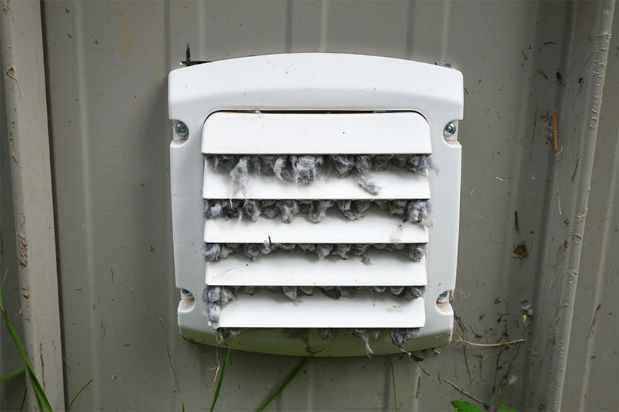 Clogged exterior dryer vent with lint buildup