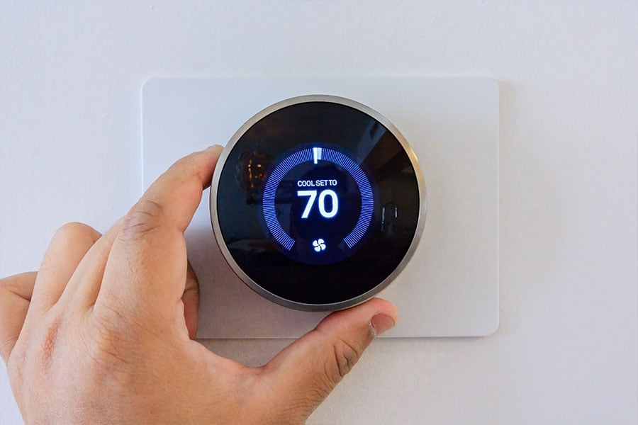 Altman’s Cooling & Heating technician diagnosing a home thermostat in Titusville, Florida.