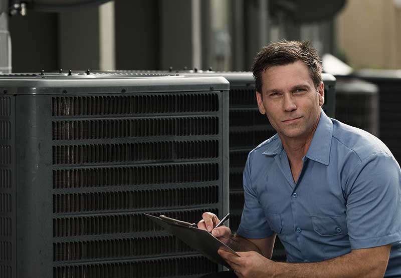 A technician with a clipboard